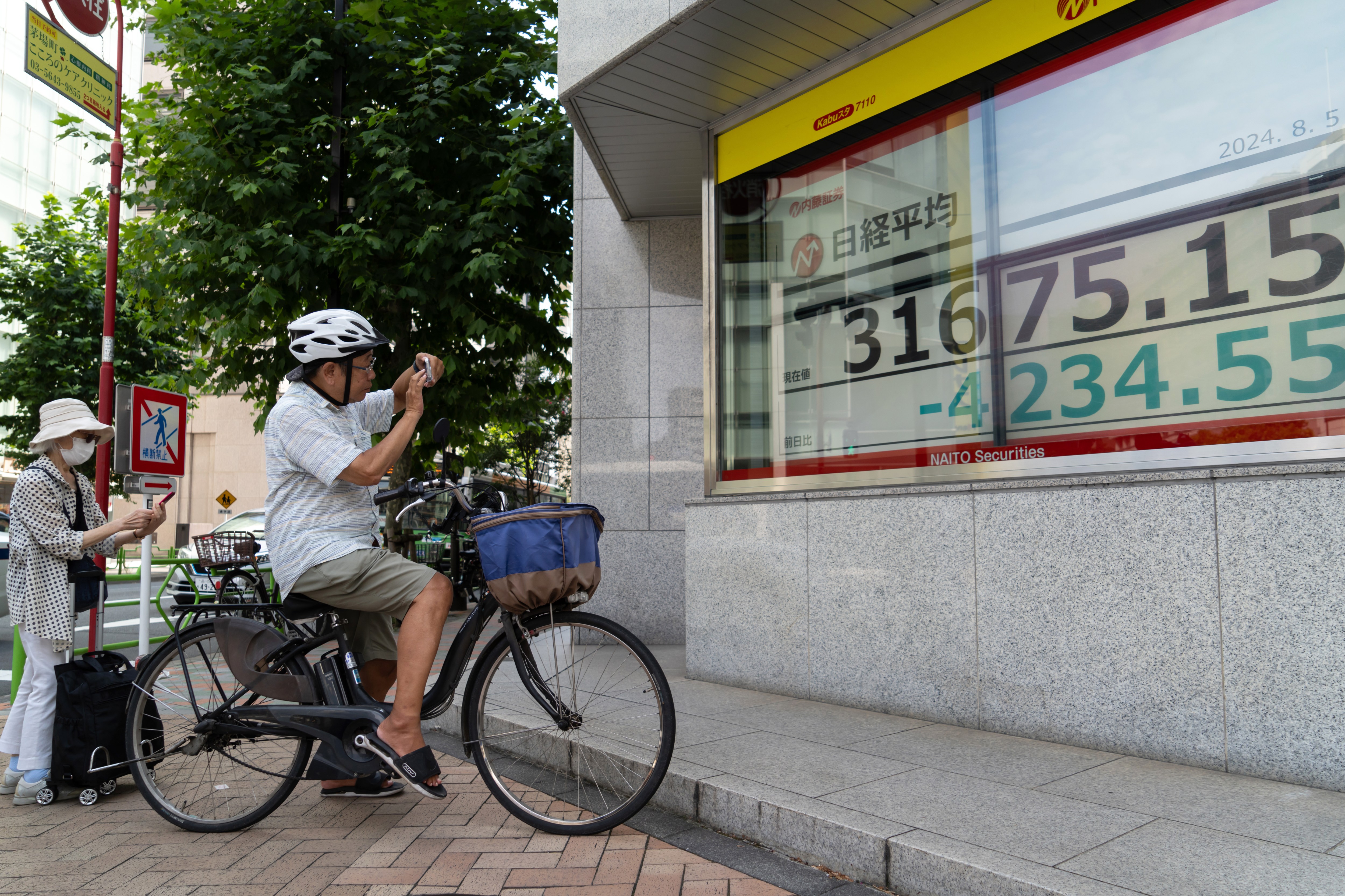 Monitors displaying the Nikkei 225 Stock Average figure outside a securities firm in Tokyo